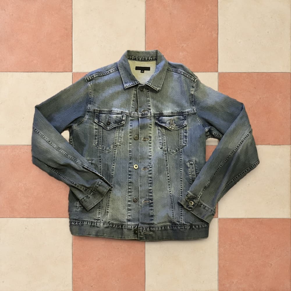 The denim jacket on a coral checker custom background with a soft shadow